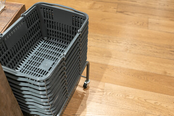 Stack of gray shopping basket in a clothes store. Shopping basket is used to carry the shopping items in a supermarket, mini market, store, or department store.
