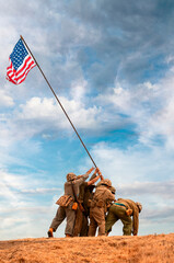 World War ll reenactors raising the United States Flag