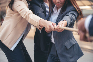 Tug of war Businesswoman Team holding hands together partnership leader teamwork. Group of business...