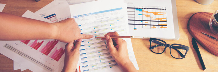 Banner Businesswoman reading financial graph charts business info with computer laptop. Panorama...