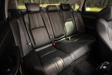 Close-up     black    leather   passenger seats. Luxury car interior