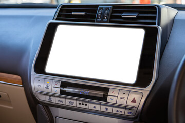 Close-up of a car panel with a white monitor for design, radio, player and control buttons.