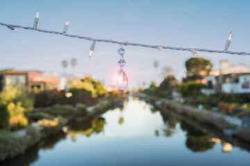 A string of lights hangs above a body of water at Venice Beach, California