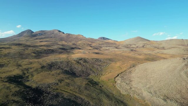 Aerial descends to bare high alpine glacial moraine terrain in Armenia