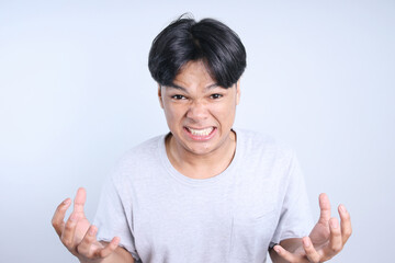 Potrait Of Angry Young Asian Man Showing Annoyed With Hands Isolated On White Background