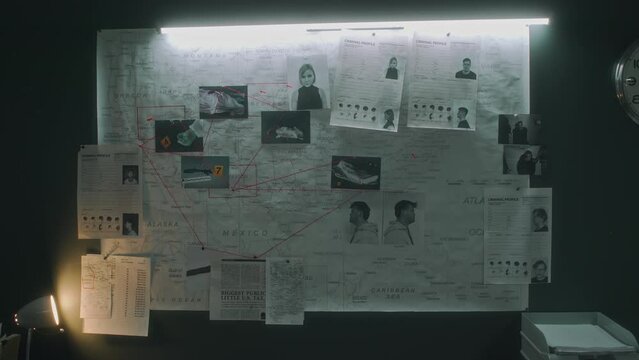 Full no people shot of crime map on wall in police department or federal bureau, with criminal profiles, APB on suspects, murder photos, illuminated by fluorescent tube lamp