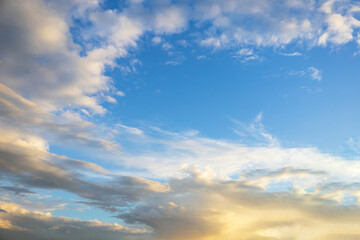 Majestic dusk. Beautiful bright blue sky with vivid golden clouds. Soft cloud in twilight. Calm cloudy sky on evening time. Abstract nature background. Fresh air, weather and freedom concept