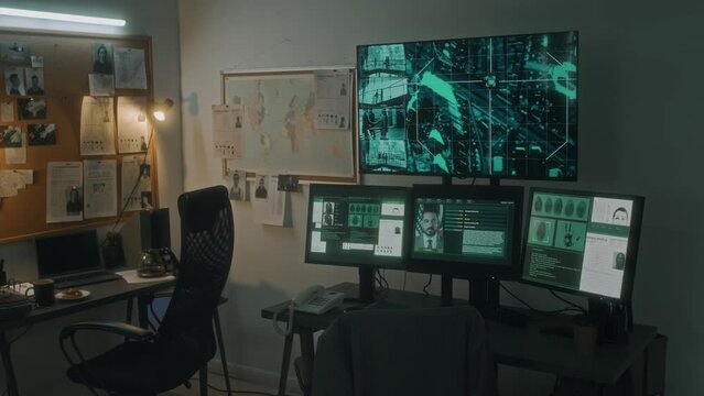 Medium no people shot of detectives office at investigative bureau or law enforcement agency, with crime maps, criminal APBs, photos of suspects, surveillance screen, computers, desks, chairs