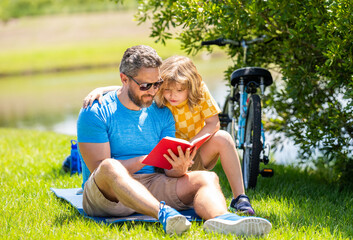 dad and son create literary adventures in nature. dad child reading time. cherished tradition for...