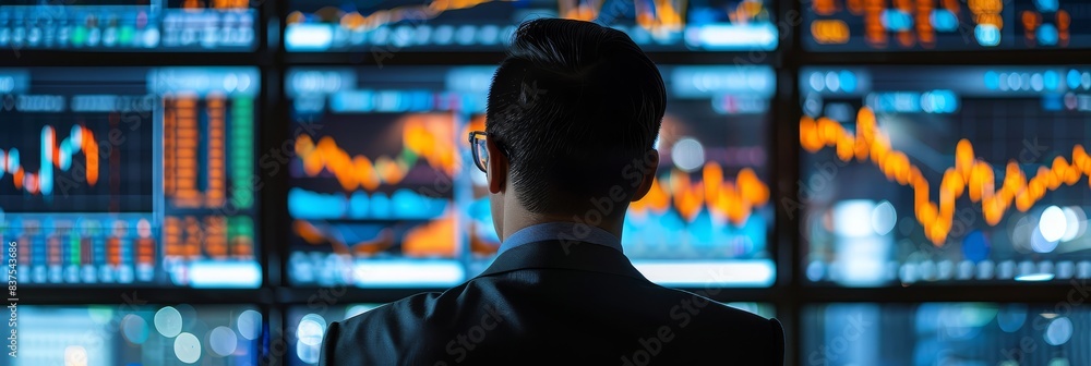 Poster businessman watching financial graphs on screens - a man in a suit observes multiple trading screens