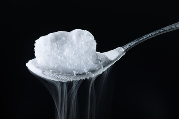 a piece of dry ice on a spoon.