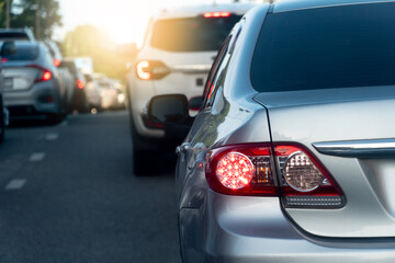 Rear side of car with turn on brake light on the asphalt road. Cars parked in queue Due to traffic...