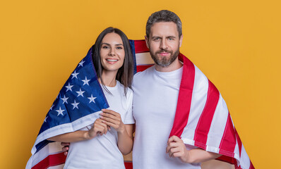 A students couple proudly posing with the American flag. patriotism of couple with the American...