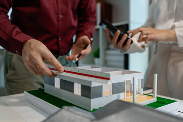 two architects are discussing about new project of the biggest housing estate company who hire their architecture company to design the best  construction