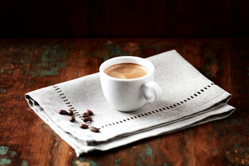 Cup of coffee on wooden background. 