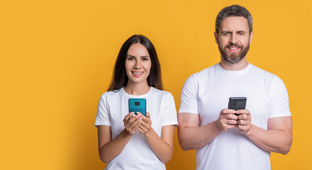 Couple chat online. Family couple blogging. Modern phone communication. Woman and man blogging using smartphone. Messaging and texting. Connected online. Chatting on phone. Copy space