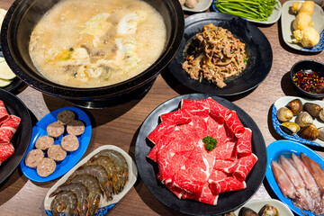 Hotpot with fresh slice of meat and seafood in restaurant