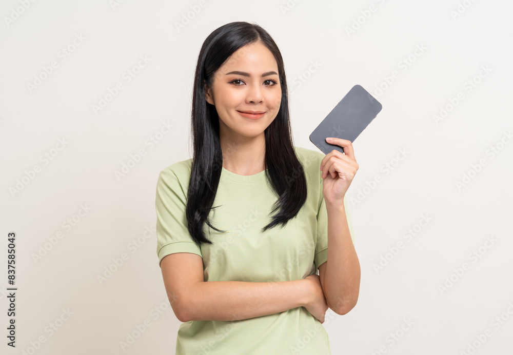 Wall mural Pretty young asian woman using cellphone standing on isolated white background. Happy Excited Beautiful young asian shopping online payment with mobile phone. Playing game on smartphone