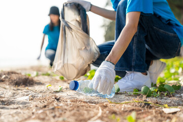 Group teamwork volunteer pick up the plastic bottle on the beach. People male and female Volunteer...