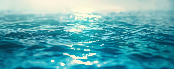 Close-up of blue ocean water with sunlight reflecting on the surface.