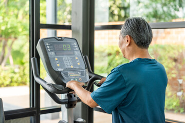 Senior old man runner exercise indoor gym. fitness man jogging wearing sportswear. Mature athlete man in sportswear Workout running on the treadmill.