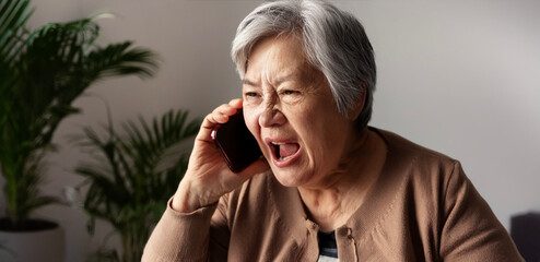 An elderly oriental woman complaining over the phone.