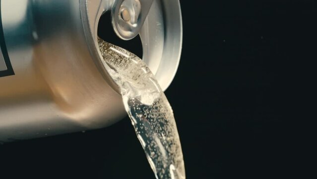 White wine, rose or off white liquid pouring out of silver can in super slow motion, black background of canned drink at 4k 800fps