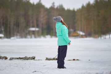 Emerald Queen of Winter: Woman in Green Jacket Standing in Snow