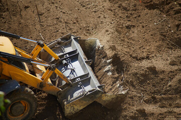 Bulldozer bucket leveling the ground, bulldozer bucket ground leveling, close-up