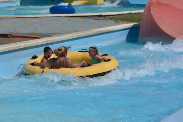 Naklejka premium Group of People Riding on a Raft in a Pool