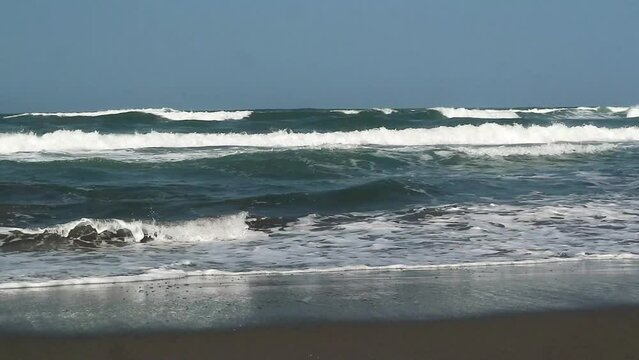 The atmosphere of the waves on the beach on a sunny day, when dawn breaks at Parangtritis Beach Yogyakarta Indonesia