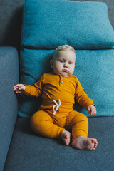 Cute little boy in a yellow suit. Clothes for babies.