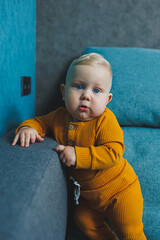 Obraz premium Cute little boy in a yellow suit. Clothes for babies.
