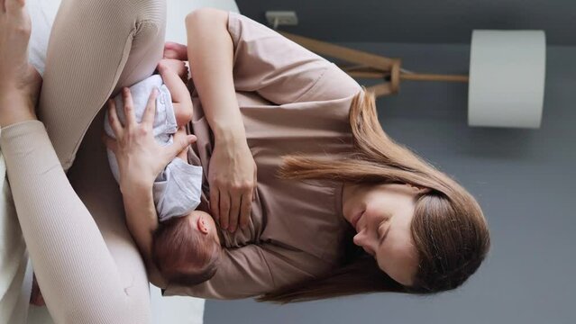 Adorable baby is suckling gently on his mother&rsquo;s breast mother is breastfeeding her tiny daughter with care mom is nursing her small boy with tenderness