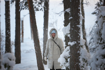 Silent Solitude, A Captivating Figure Amidst the Snow-Cloaked Enclave of Trees
