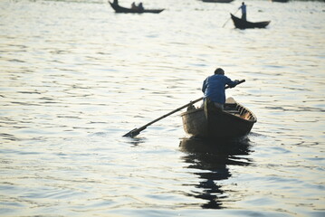 A Boatman floating his boat at the river named Buriganga