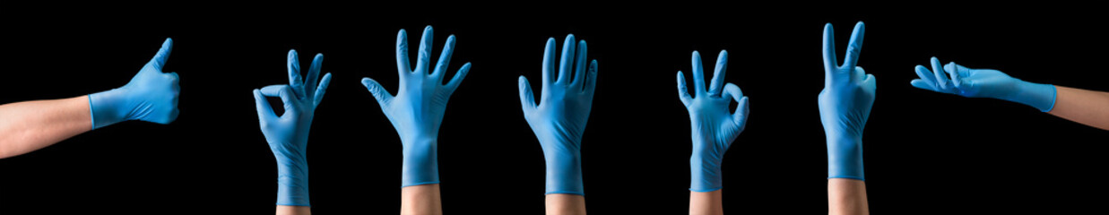 Doctor's hand in sterile medical gloves showing gesture or something on black