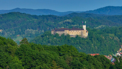 AERIAL: Panoramic view of a historic Ljubljana surrounded by the lush forests.