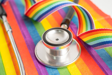 Stethoscope on rainbow flag background, symbol of LGBT pride month celebrate annual in June social,...