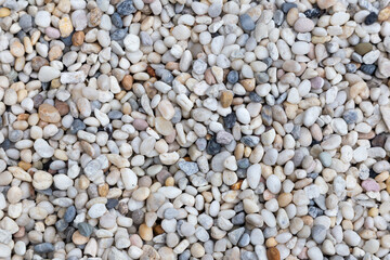 White round pebbles laid on the floor as an image for making the background.