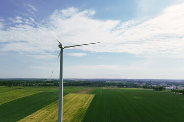 Wind turbine in fields illustrating sustainable future and wind power