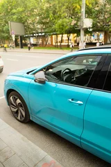 blue car with city street © Anna Ismagilova