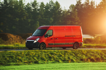 Delivery van in motion on green country road