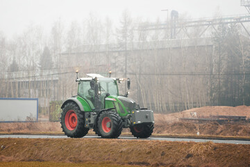 Expensive European green tractor on a rural road