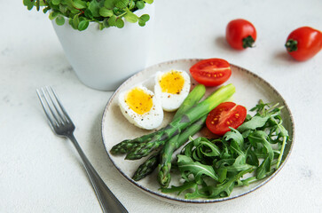 Fresh Spring Salad With Boiled Eggs, Asparagus, and Tomatoes on a Bright Day