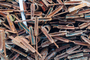 Rusted metal scaffolding piled up waiting to be dumped or recycled