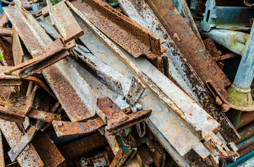Rusted metal scaffolding piled up waiting to be dumped or recycled