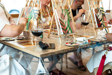 Sip and Paint Event. Art class with friends enjoying painting and wine