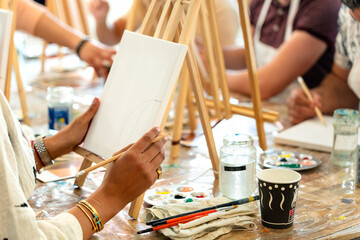Sip and Paint Event. Friends painting together at a fun art class