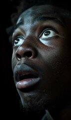 A close up of a man with dark skin looking at something. AI.